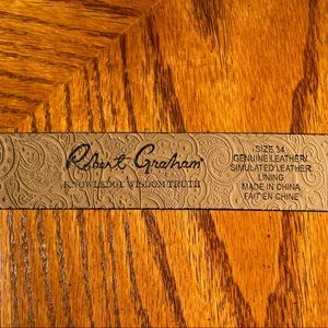 Stylish Robert Graham belt with engraved buckle and a snakeskin texture